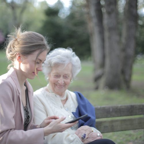 daughter-explaining-elderly-mother-how-using-smartphone-3791666